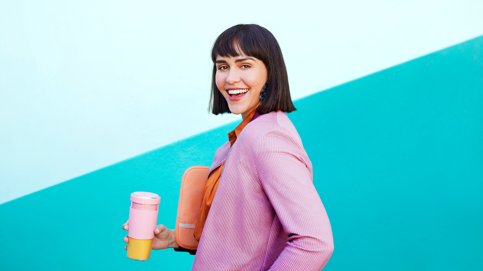Portrait of business person with travel coffee mug, smiling